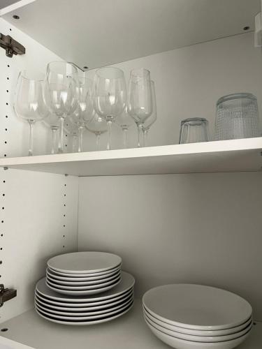 a bunch of wine glasses and plates on a shelf at Mariposa Azul in Adeje