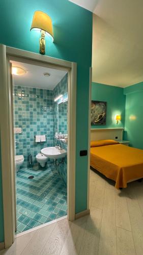 a bedroom with a bed and a bathroom with a sink at Hotel Bright in Rome