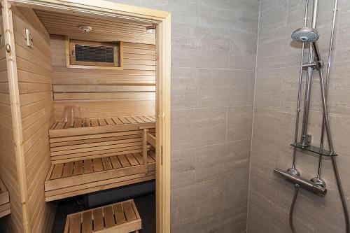 a sauna in a bathroom with a shower at Cozy Alpine-Style Apartment in the Heart of Levi with Private Sauna & Fireplace in Levi