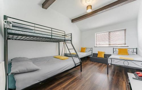a bedroom with two bunk beds and a desk at Logan Lodge, Great Yarmouth - for your large group! in Great Yarmouth