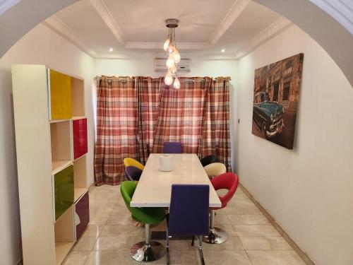 a dining room with a table and colorful chairs at S J Lodge 