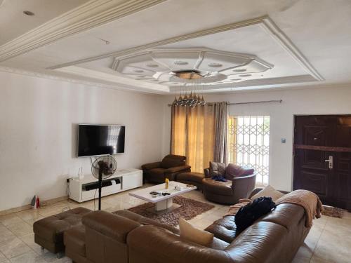 a living room with a couch and a tv at S J Lodge 