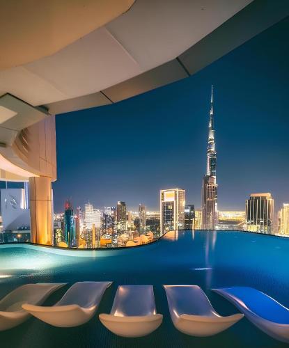 a room with chairs and a view of a city at Burj Khalifa Downtown Views - Highest Infinity Pool in Downtown in Dubai