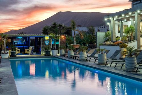 a hotel swimming pool with a mountain in the background at Exclusive SUPER-SIZE Holiday home - 12 bed,11 bath with Amazing Facilities, Sea and Mountain Views in Tías