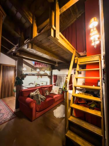 a living room with a red couch and bunk beds at CasaVacanze Roccaraso in Roccaraso