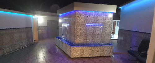 a large shower in a room with blue lights at The Sun Gate in Agadir