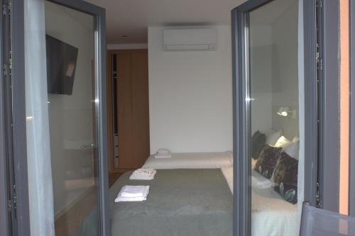 een kamer met een glazen schuifdeur en een bed bij Relax & Travel in Almada