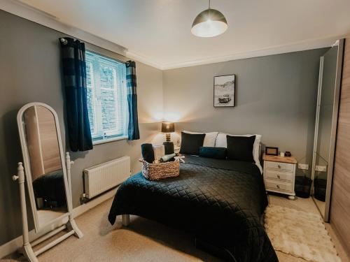 a bedroom with a bed and a mirror in it at 5 Mariners Wharf in Newhaven