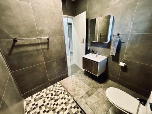 a bathroom with a sink and a shower and a toilet at 16 on Les De Jager in Pietermaritzburg