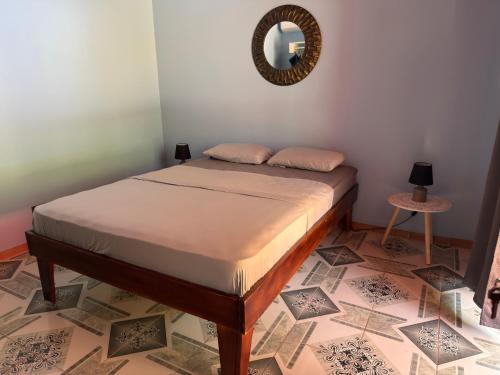 a bedroom with a bed with a mirror on the wall at Hotel Carmen Costa Coral in Tambor