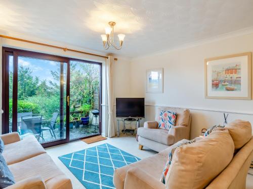 a living room with a couch and a tv at River View in Wadebridge