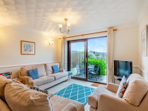 a living room with two couches and a television at River View in Wadebridge