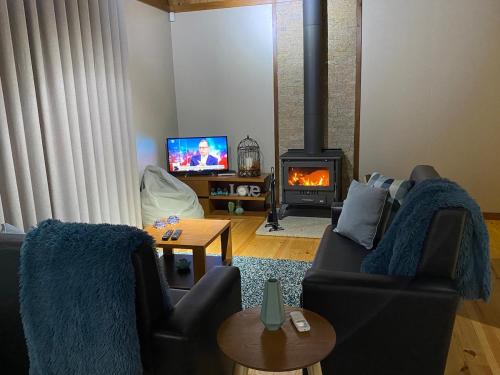 a living room with a couch and a fireplace at Chalé de montanha com Lareira in Vieira do Minho
