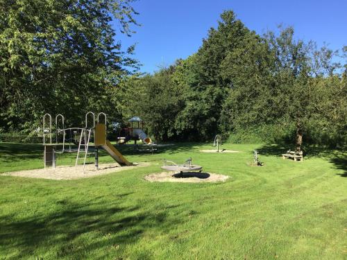 a park with a playground with a slide at Vakantiehuis ontdek Zuid - Limburg in Simpelveld