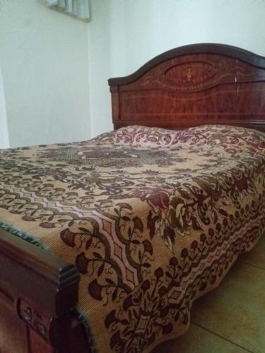 a bed in a bedroom with a wooden bed frame at Villa Promentilla in Inosloban