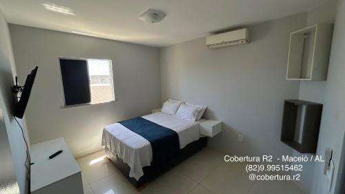 En eller flere senge i et værelse på Cobertura R2 Maceió