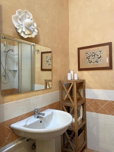 a bathroom with a sink and a mirror at BoscoLago apartment Lake Iseo & Franciacorta in Iseo