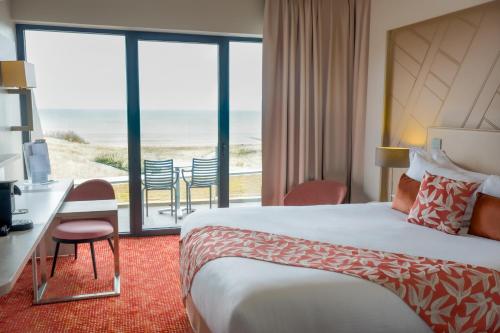 une chambre d'hôtel avec un lit et une vue sur l'océan dans l'établissement Thalazur Cabourg - Hôtel & Spa, à Cabourg