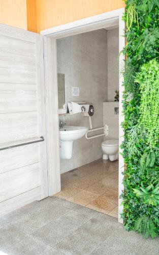 a bathroom with a toilet and a sink at Hotel Riviera in Mierzyn