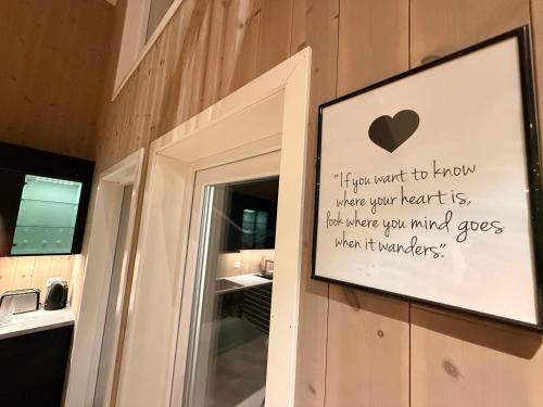 a sign on a bathroom door with a heart on it at Finnvika panorama Cabin 2 in Vestvågøya