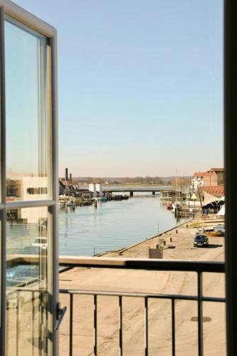 a view of a marina from a window at New Three-Story Harbour House In Kerteminde in Kerteminde