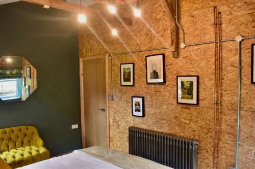 a bedroom with a bed and a wall with pictures at Ty Llaeth in Llanstephan