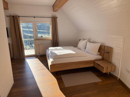 a bedroom with a bed in a room with a window at Zum Kaiserwirt in Heppenheim an der Bergstrasse