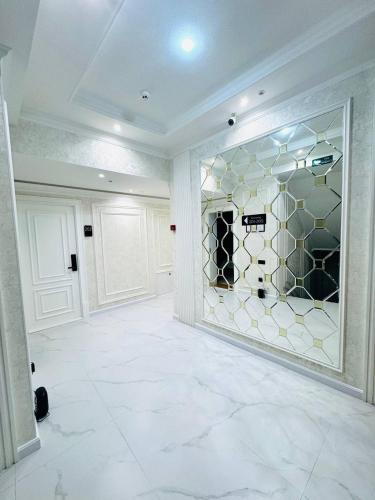 a large white room with a glass wall at The Moonya Hotel in Samarkand