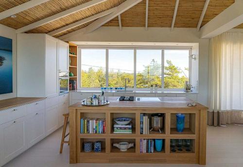 a kitchen with a counter with a sink and a window at Architectural Gem Between Risør And Kragerø in Søndeled