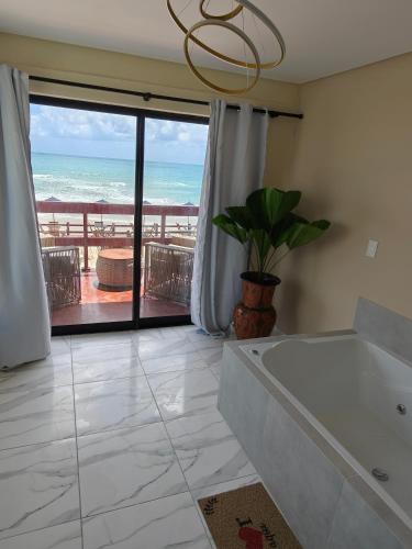 a bathroom with a view of the ocean at Pousada Porto Meu Amor in Porto De Galinhas