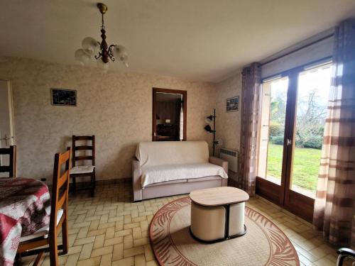 a bedroom with a bed and a table and a window at Spacieux logement calme avec jardin privé - Parking inclus, animaux acceptés - FR-1-432-8 in Annecy