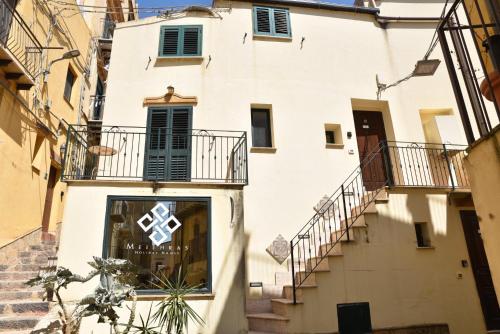 a building with a cross on the side of it at Meithras Holiday Homes in Agrigento
