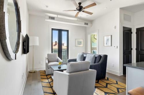 a living room with two chairs and a ceiling fan at Fire Tower Classy 1BR in Downtown Charleston in Charleston