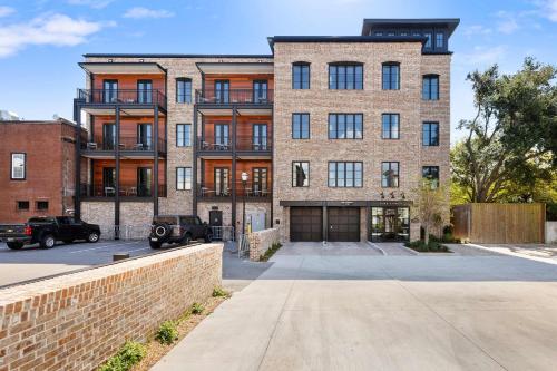 a large brick building with a driveway at Fire Tower Downtown Gem 1BR with Balcony & Views in Charleston