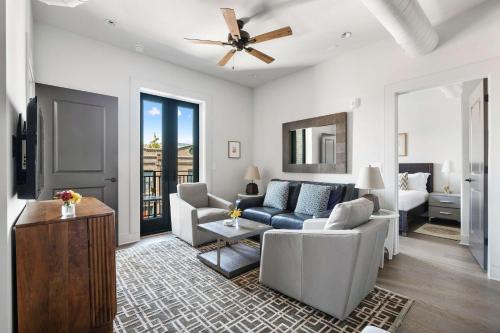 a living room with a couch and a bed at Fire Tower Luxe 2BR KingSuites & Private Balcony in Charleston