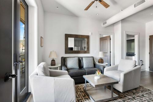 a living room with a couch and two chairs at Fire Tower Luxe 2BR KingSuites & Private Balcony in Charleston