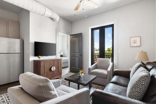 a living room with a couch and a table at Fire Tower Luxe 2BR KingSuites & Private Balcony in Charleston