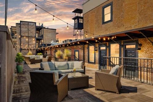 a patio with couches and chairs on a balcony at Perfect Location - King Street Condo in Charleston