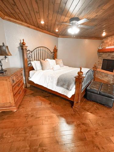 a bedroom with a large bed and a fireplace at The Royal Chateau-5BED6BATHPoolHottub-20PP in Osage Beach