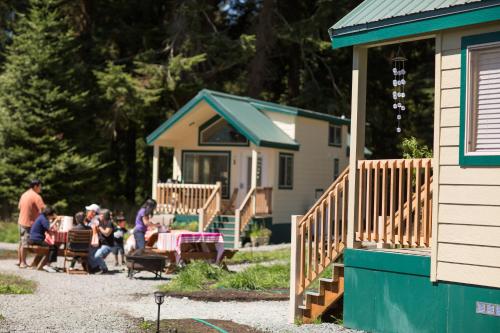 a group of people sitting at tables outside of a house at Sheltered Nook On Tillamook Bay in Bay City