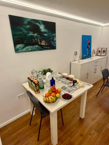 a white table with fruit on it in a room at LIGHTHOUSE APPARTEMENTS in Warnemünde