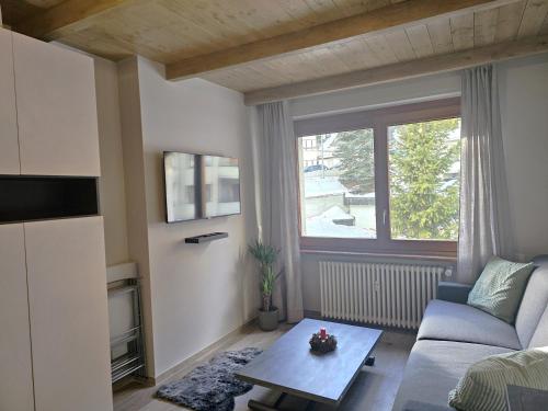 a living room with a couch and a table at Moda Apartments 47 in Sestriere