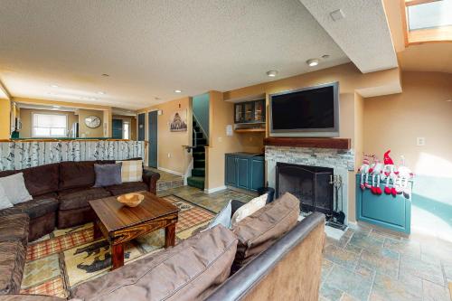a living room with a couch and a fireplace at Happy Haven in Lincoln
