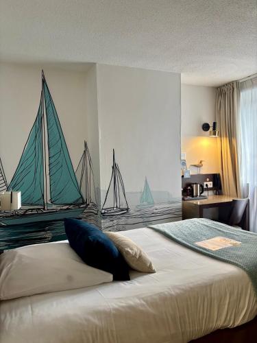 a bedroom with a bed with two sailboats on the wall at Ambassadeur Hotel - Cherbourg Port de Plaisance in Cherbourg en Cotentin