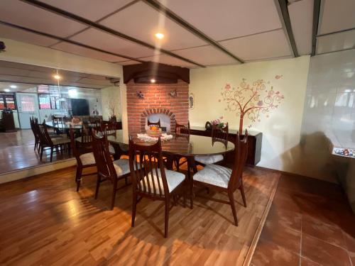 a dining room with a table and chairs and a fireplace at Depa 1 habitación equipado coyoacan in Mexico City