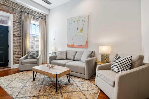 a living room with two couches and a coffee table at King Street Condo - Endless Outdoor Space in Charleston