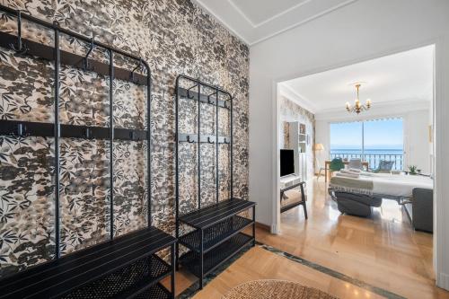 a living room with a piano and a room with a bedroom at Le COQ Livieri - AC- WiFi - Seafront - town centre in Menton