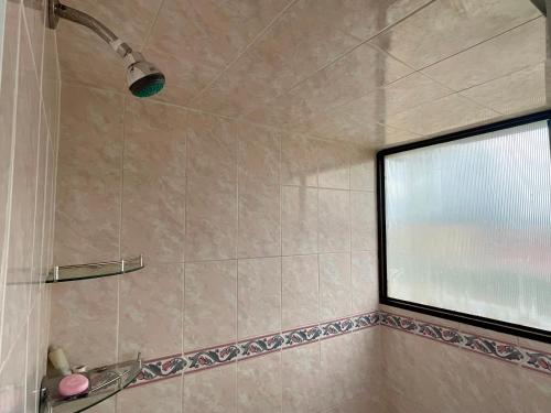 a bathroom with a shower with a window at Depa 1 habitación equipado coyoacan in Mexico City