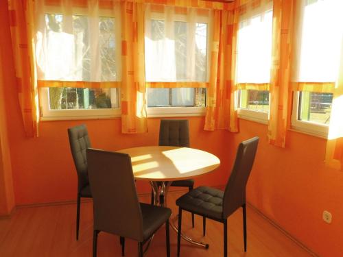 a table and chairs in a room with windows at Holiday Home mit Pool by Interhome in Radewege