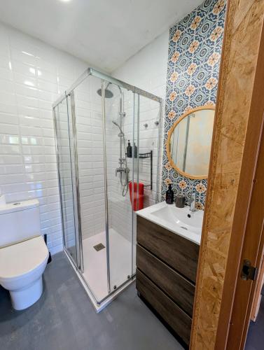 a bathroom with a shower and a toilet and a sink at la caseta viva in Olvan